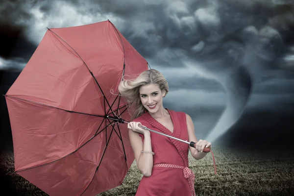 Smiling blonde holding umbrella — Stock Photo, Image