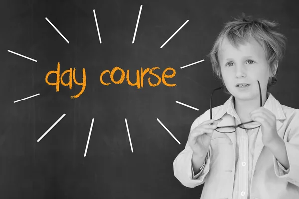 Day course against schoolboy and blackboard — Stock Photo, Image