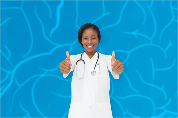 Young nurse giving thumbs up — Stock Photo, Image