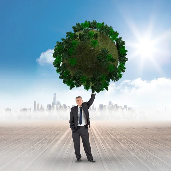 Businessman holding green sphere — Stock Photo, Image