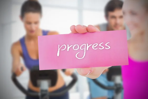 Woman holding pink card saying progress — Stock Photo, Image