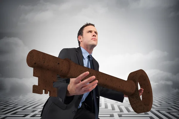 Businessman carrying large key — Stock Photo, Image