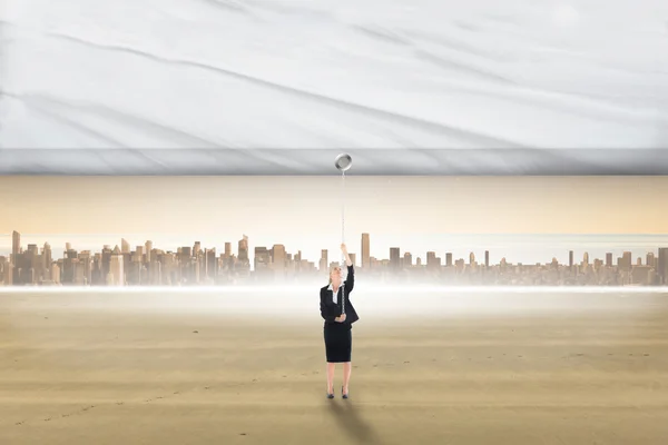 Businesswoman pulling a white screen — Stock Photo, Image