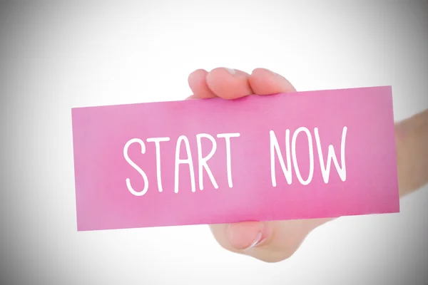 Woman holding pink card saying start now — Stock Photo, Image