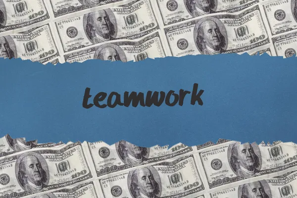 Teamwork against digitally generated sheet of dollar bills — Stock Photo, Image