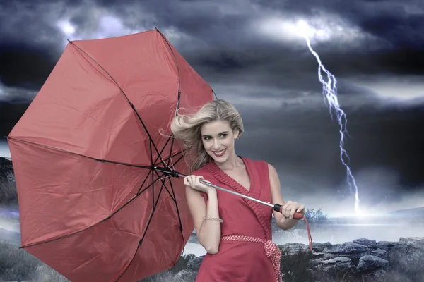 Smiling blonde holding umbrella — Stock Photo, Image