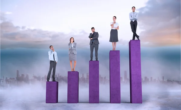 Business people on bar chart — Stock Photo, Image