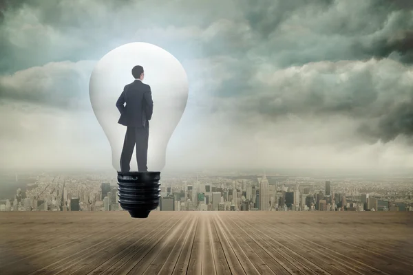 Thinking businessman in light bulb — Stock Photo, Image