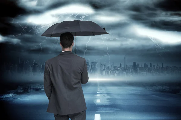 Classy businessman holding grey umbrella — Stock Photo, Image