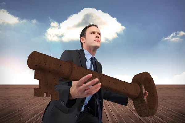 Businessman carrying large key — Stock Photo, Image