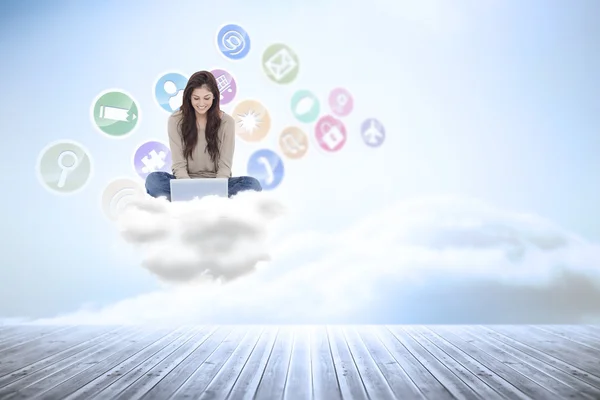 Brunette sitting on floor using laptop — Stock Photo, Image