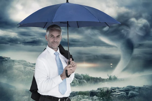 Businessman holding blue umbrella — Stock Photo, Image