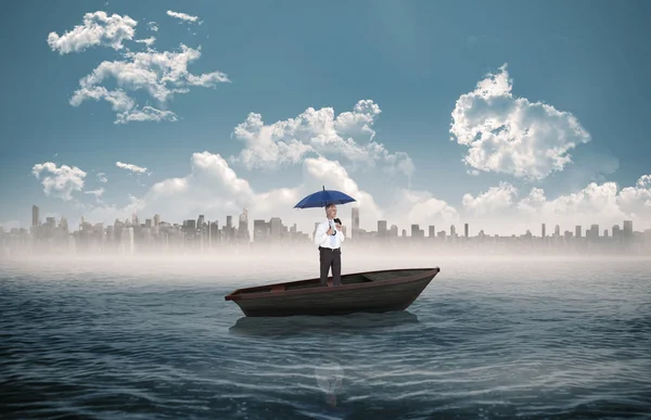 Businessman holding umbrella in a sailboat — Stock Photo, Image