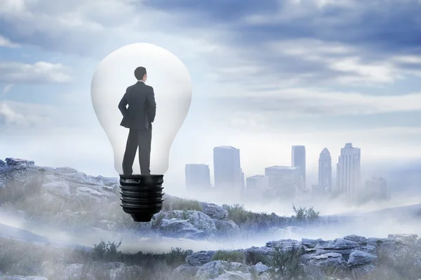 Thinking businessman in light bulb — Stock Photo, Image