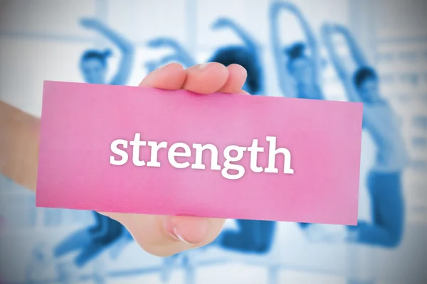 Woman holding pink card saying strenght — Stock Photo, Image