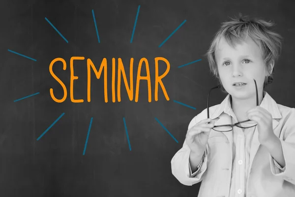 Seminar against schoolboy and blackboard — Stock Photo, Image