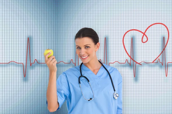 Surgeon holding an apple — Stock Photo, Image