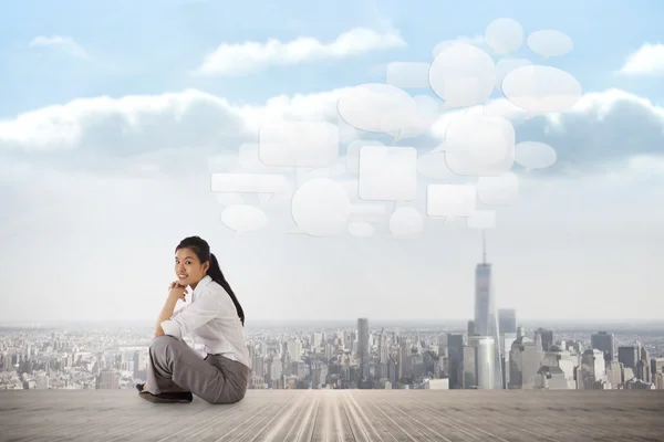 Businesswoman sitting cross legged — Stock Photo, Image