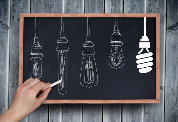 Hand drawing light bulbs with chalk — Stock Photo, Image