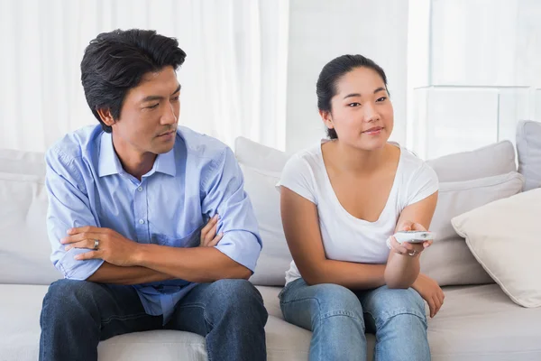 Man looking at girlfriend changing channel — Stock Photo, Image