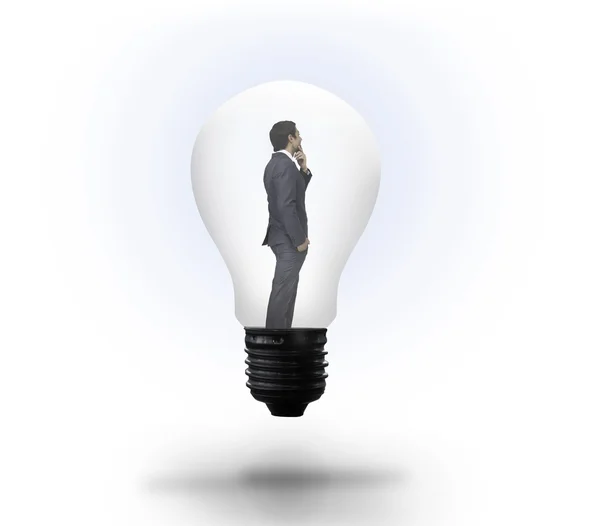 Thinking businessman in light bulb — Stock Photo, Image