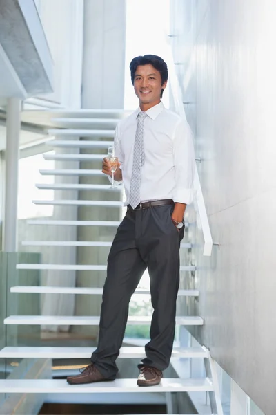 Serious man looking at camera holding champagne flute — Stock Photo, Image