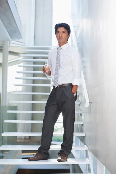 Serious man looking at camera holding champagne flute — Stock Photo, Image