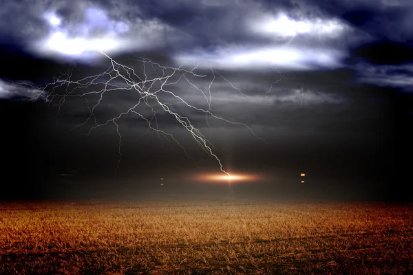 Stormy sky over field with lightning — Stock Photo, Image