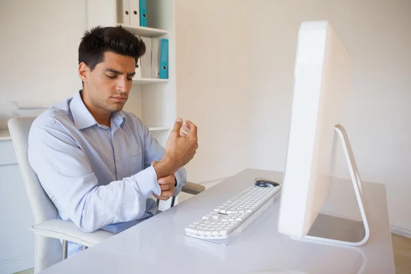 Casual businessman touching his sore wrist — Stock Photo, Image