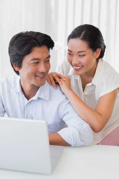 Lyckliga paret använder laptop tillsammans — Stockfoto