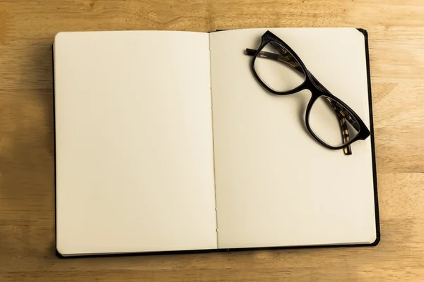Overhead of reading glasses with notebook — Stock Photo, Image