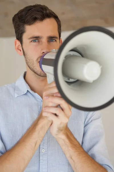 Casual businessman talking through megaphone — Stock Photo, Image