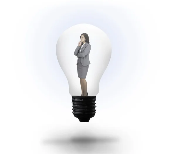 Thinking businesswoman in light bulb — Stock Photo, Image
