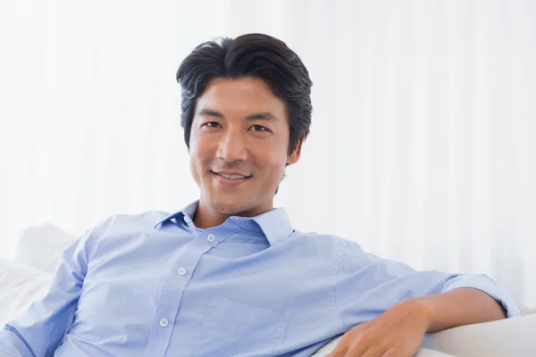 Happy man relaxing on couch Stock Image