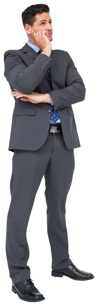 Мыслящий бизнесмен в сером костюме Стоковая Картинка