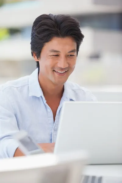 Lycklig man använder sin laptop — Stockfoto