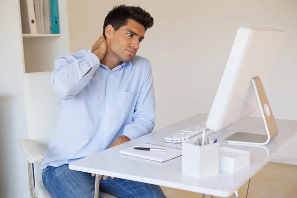 Casual businessman touching his sore neck — Stock Photo, Image