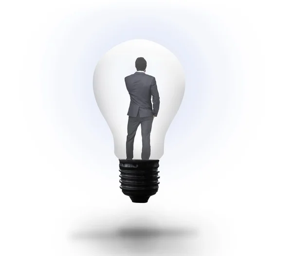 Мыслящий бизнесмен в лампочке — стоковое фото
