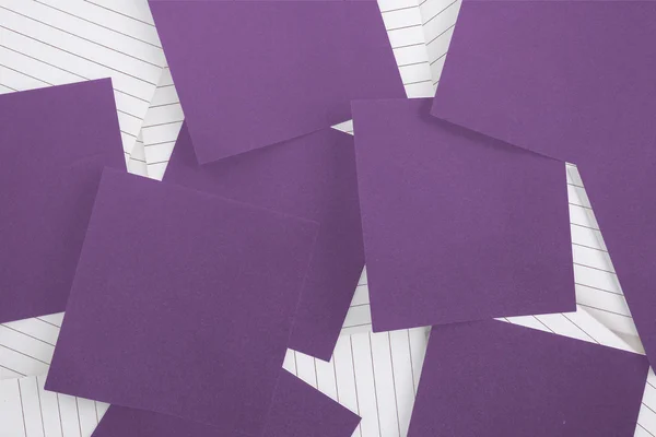 Purple paper strewn over notepad — Stok fotoğraf