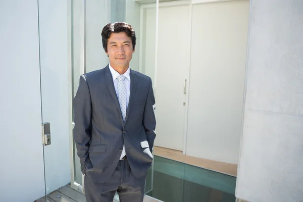 Confident estate agent standing at front door — Stock Photo, Image