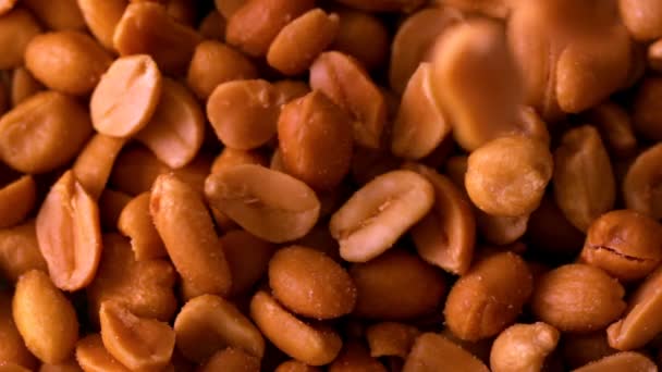 Roasted peanuts pouring onto more — Stock Video