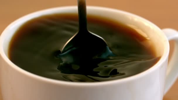 Teaspoon stirring coffee in a cup — Stock Video