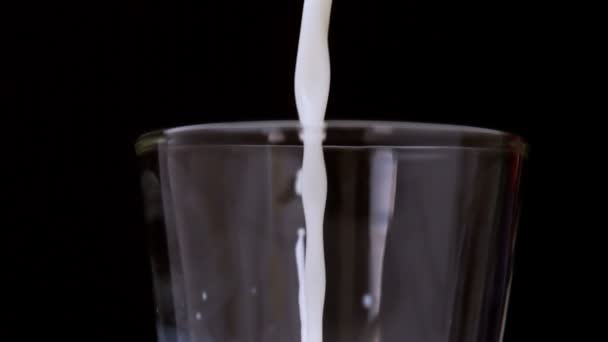 Молоко наливается в стакан — стоковое видео