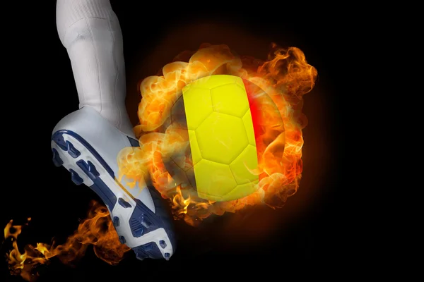 Football player kicking flaming belgium ball — Stock Photo, Image