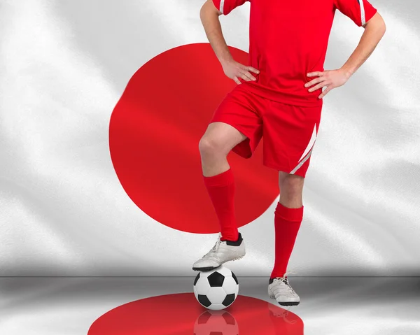 Composite image of football player standing with ball — Stock Photo, Image