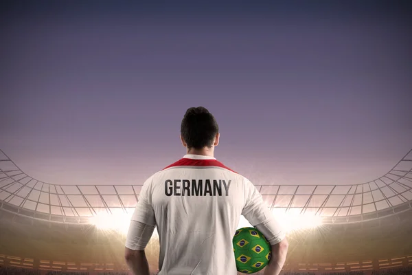 Composite image of germany football player holding ball — Stock Photo, Image