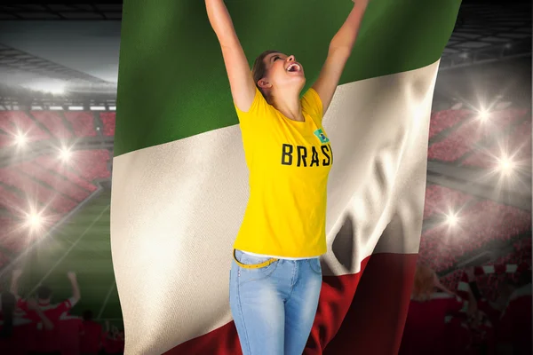 Excited football fan in brasil tshirt holding flag — Stock Photo, Image