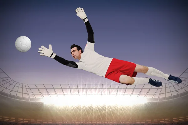 Composite image of goalkeeper in white making a save — Stock Photo, Image