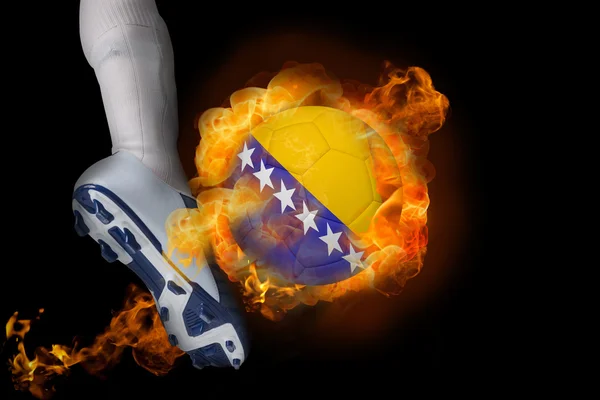 Football player kicking flaming bosnia ball — Stock Photo, Image