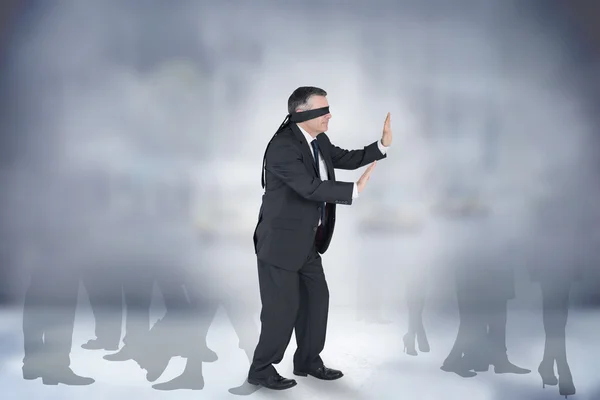 Composite image of mature businessman in a blindfold — Stock Photo, Image